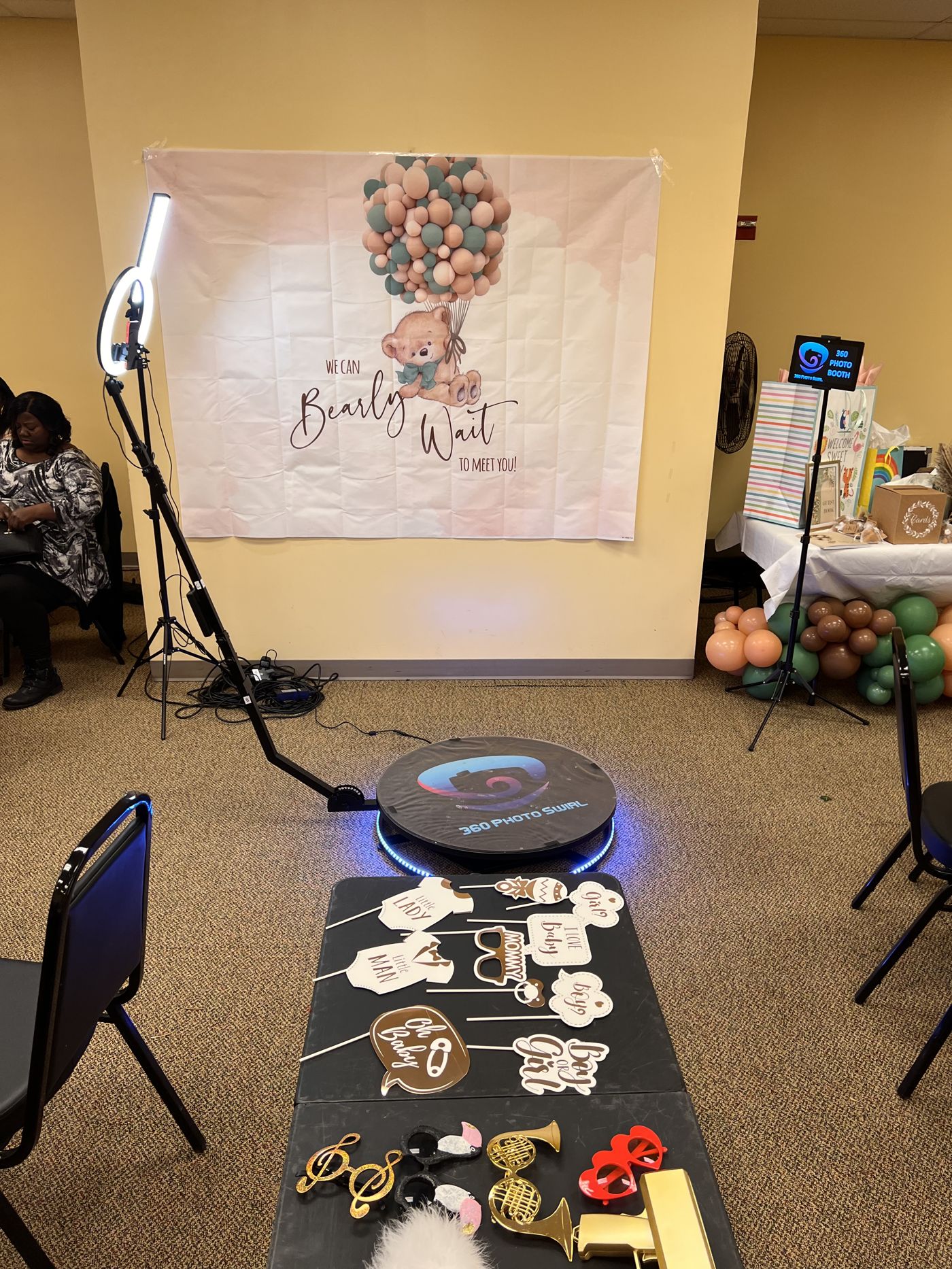 360 platform with teal ring light at a baby shower with a bear balloon backdrop