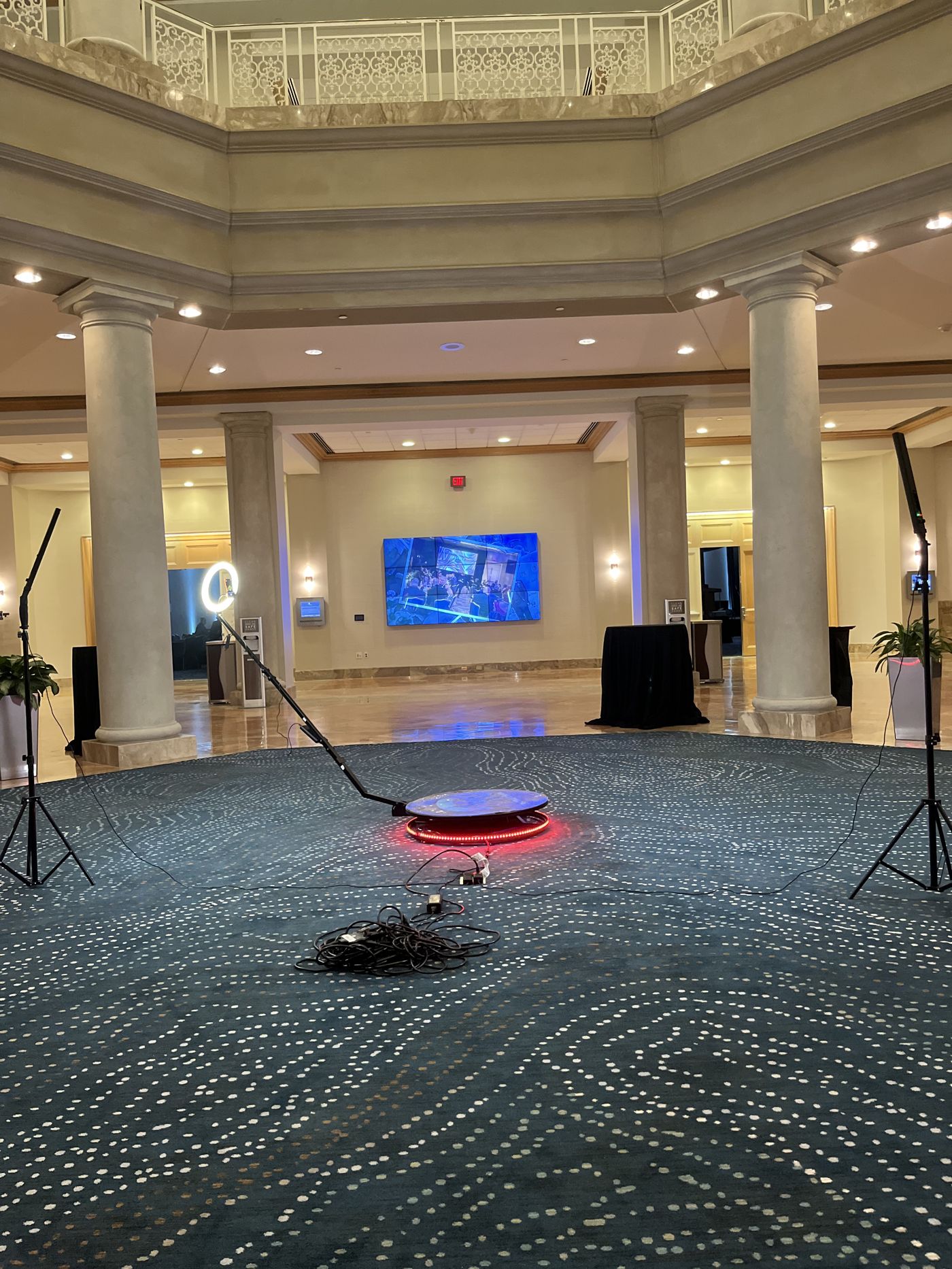 360 platform with red ring light in a grand marble hotel atrium