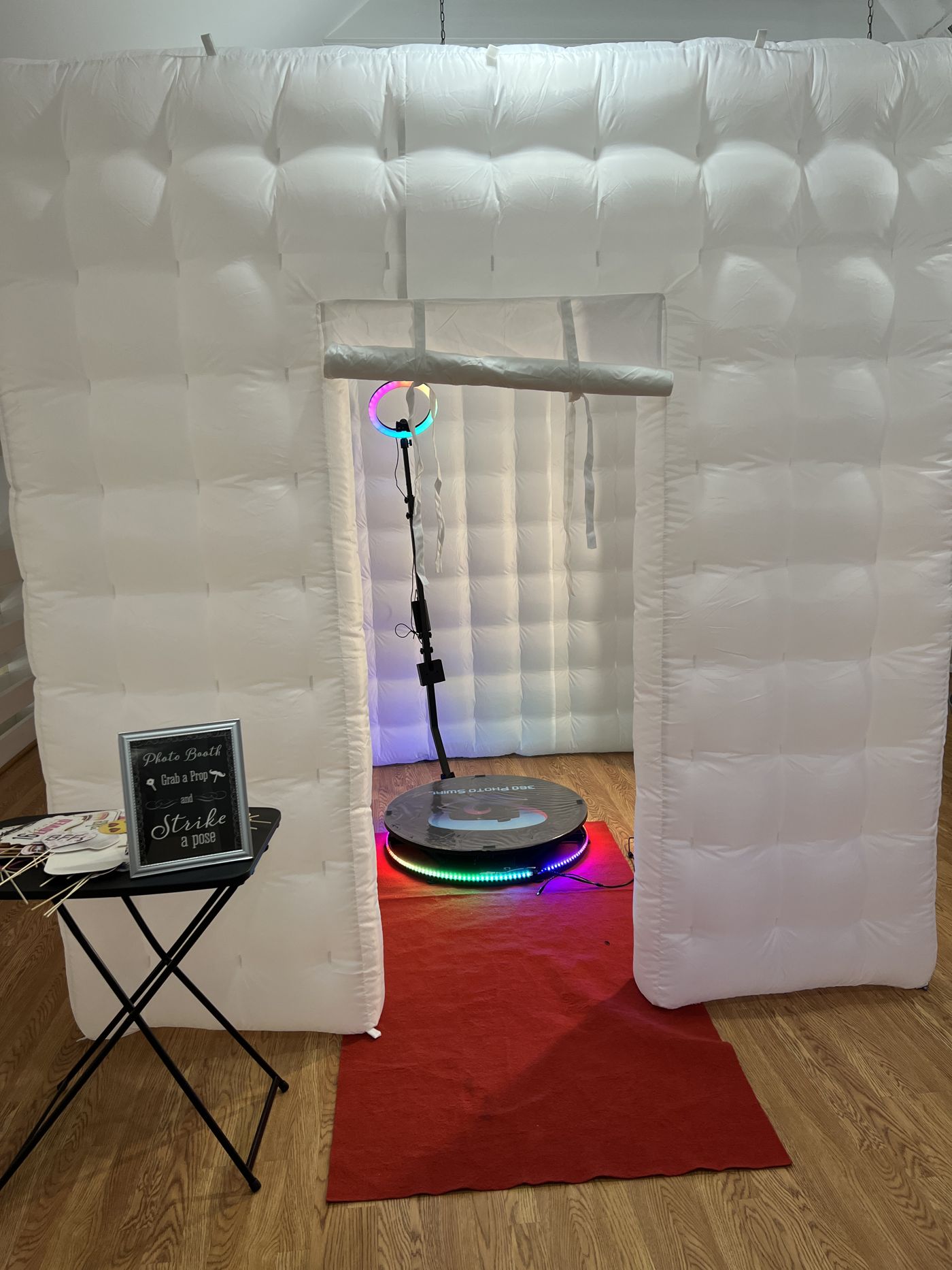 360 platform inside a white inflatable photo booth structure with rainbow ring light