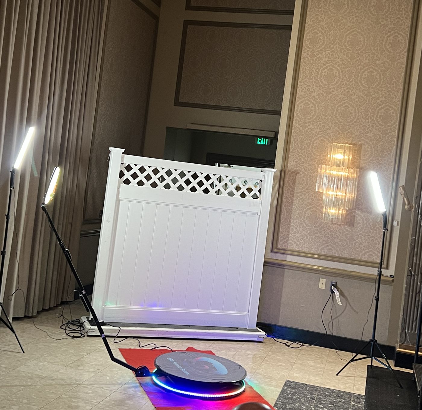 360 platform in front of a white lattice backdrop in a hotel ballroom