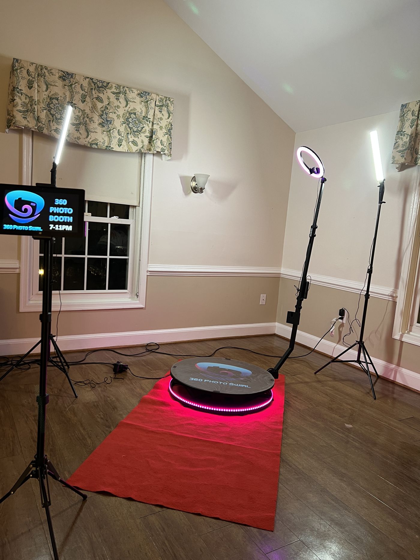 360 platform with pink ring light and red carpet in a floral-curtained room