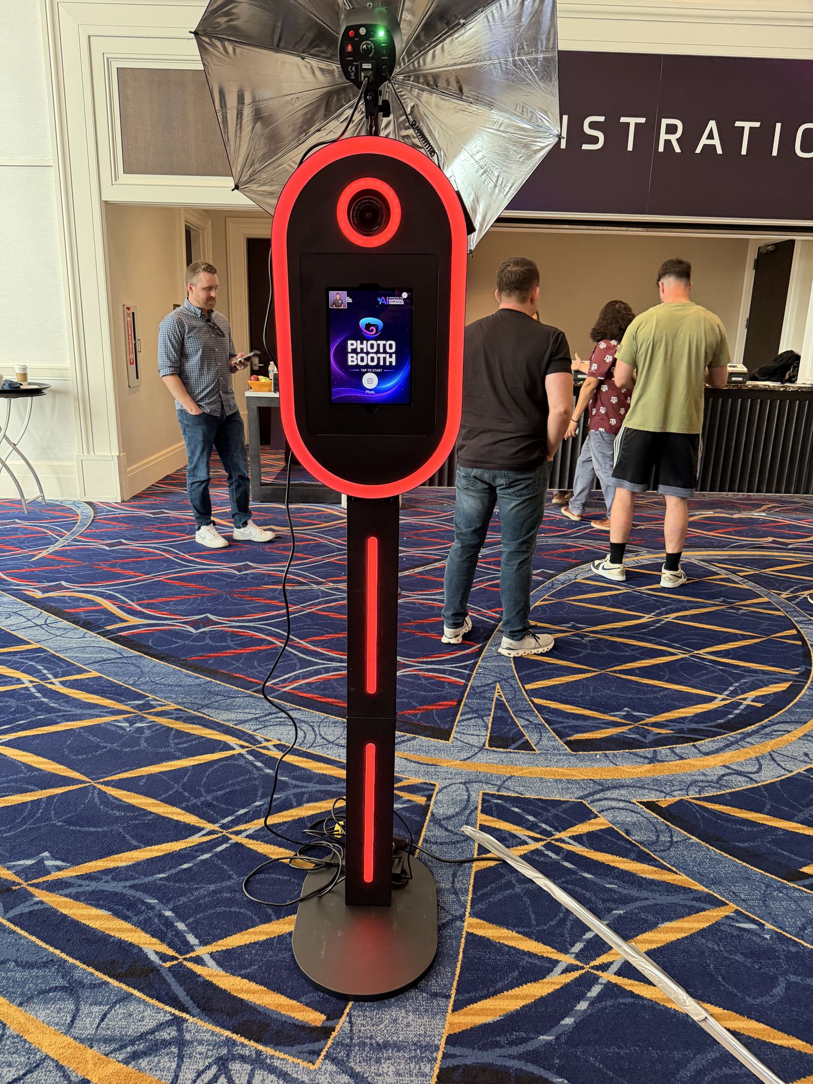 360 Photo Swirl premium Tower photo booth with red LED ring at a corporate conference
